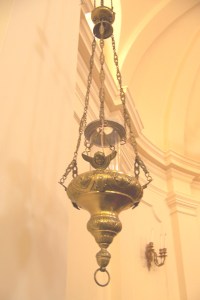 Our brass Sanctuary Lamp, which is lit to signify the presence of the Holy Sacrament.