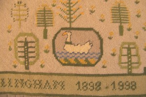 Detail showing the Bramley family crest: a swan with a circlet of brambles.